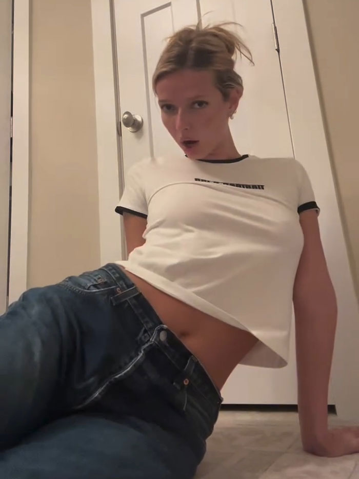Apple Martin posing casually in jeans and a white crop top for self-portrait modeling campaign video announcement
