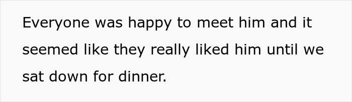 Man struggling to control his hunger while girlfriend looks embarrassed in front of family during turkey dinner.