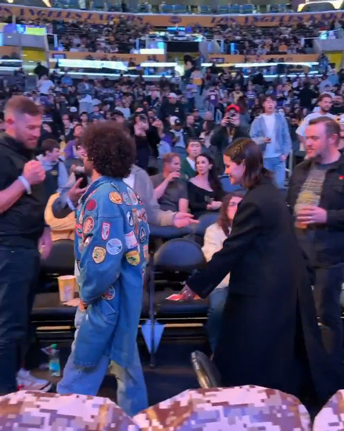 Benny Blanco giving cold treatment to Selena Gomez at a crowded event as fans capture the viral moment on their phones. Benny Blanco giving cold treatment to Selena Gomez at a crowded event as fans capture the viral moment on their phones.