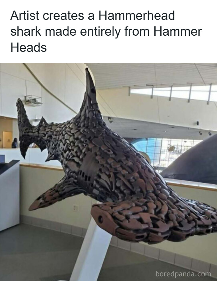 Sculpture of a hammerhead shark made from numerous hammer heads, showcasing animal antics in creative art form.