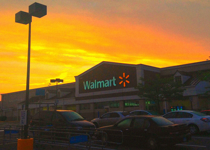 Walmart store exterior at sunset with cars parked, illustrating jobs that revealed industry secrets to customers.