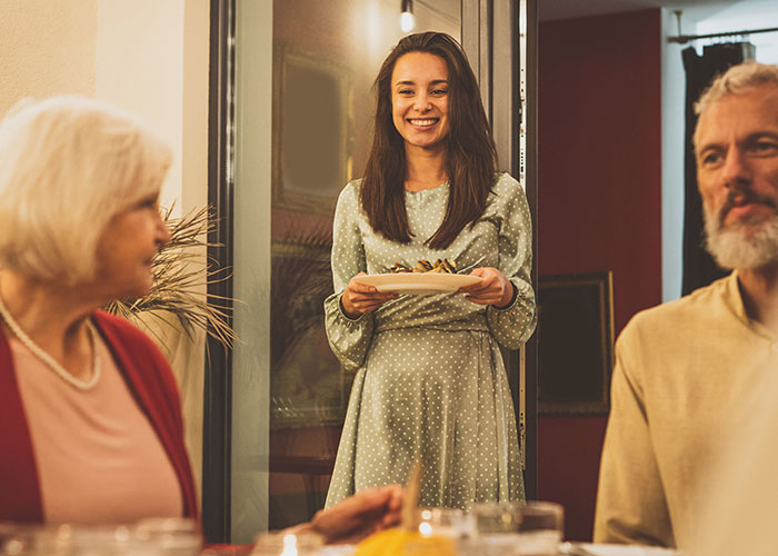 Young woman rethinking her engagement during tense holiday dinner after fianc&eacute;&rsquo;s lie about her family causes conflict.