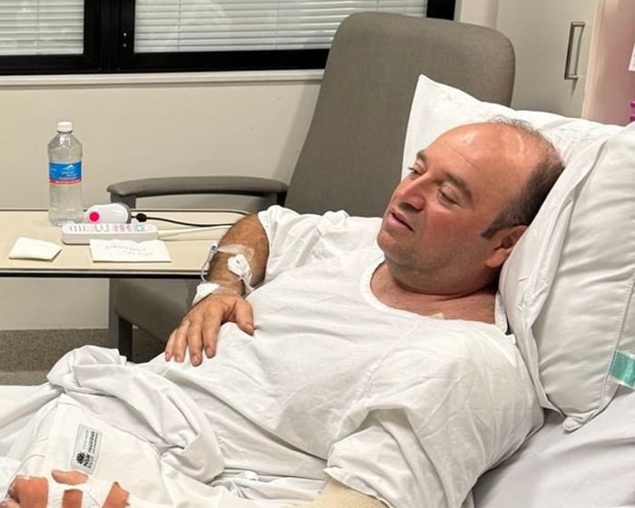 Man lying in hospital bed receiving treatment after Bondi Beach confrontation with attacker, as lawyer reveals update.