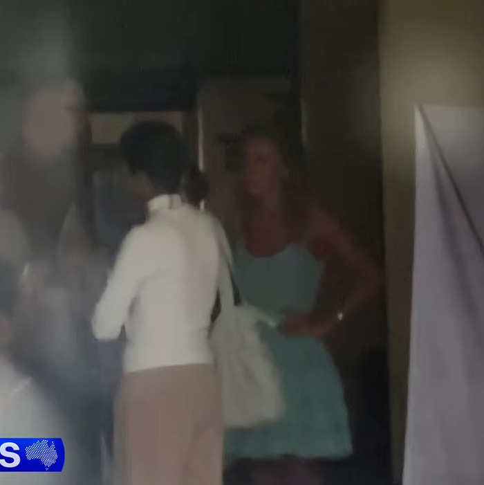 Blurry image of two women indoors, one in a white top and the other in a blue dress, related to adult star Bonnie Blue arrest. Blurry image of two women indoors, one in a white top and the other in a blue dress, related to adult star Bonnie Blue arrest.