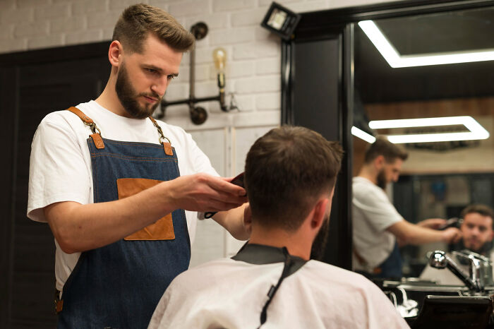 Barber carefully making a small decision while cutting a client's hair, illustrating unexpected life-altering consequences.