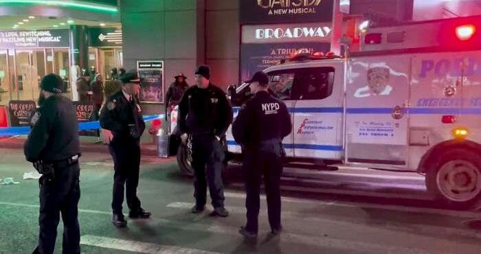 NYPD officers stand near an ambulance at a NYC street scene after a Marvelous Mrs. Maisel actress lost her life crossing the road.