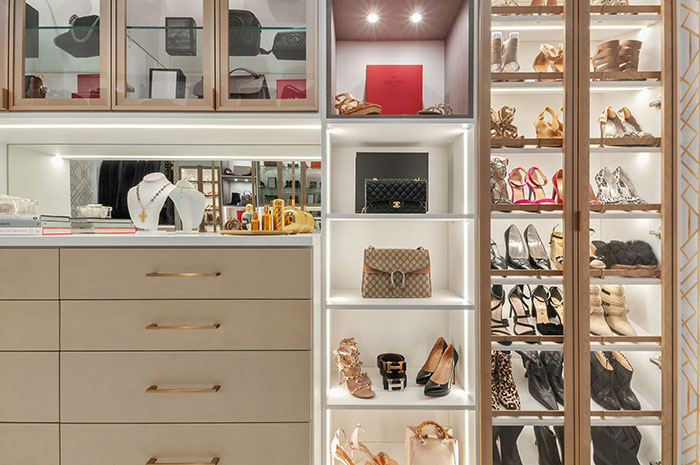 Luxury closet with designer shoes, handbags, and accessories showcasing the rich people lifestyle and exclusive reality.