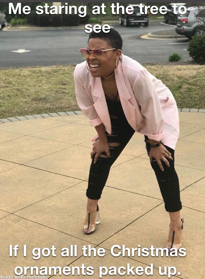 Woman squinting and leaning forward humorously, representing funny Christmas memes about holiday decoration struggles.