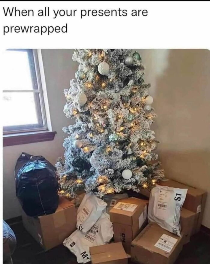 Christmas tree surrounded by dozens of prewrapped packages and boxes, illustrating funny Christmas memes about gifts.