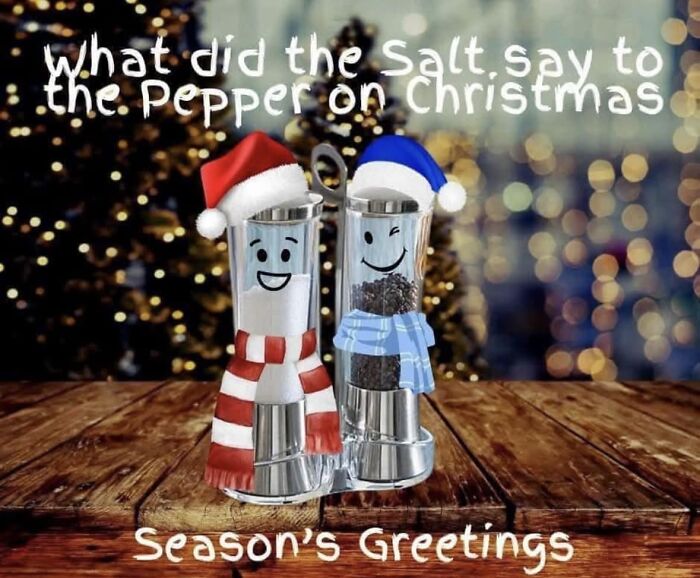 Salt and pepper shakers with hats and scarves on a wooden table, featuring a funny Christmas meme background.