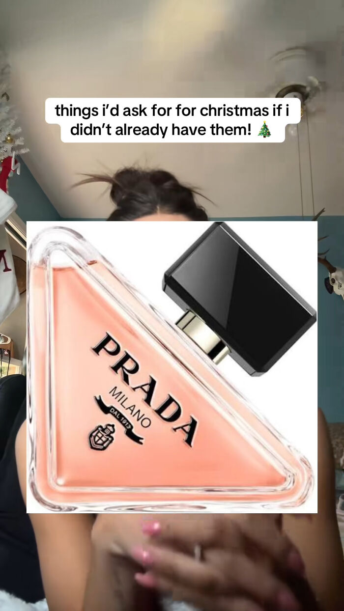 Prada perfume bottle featured as a highly recommended Christmas gift item in a festive setting.