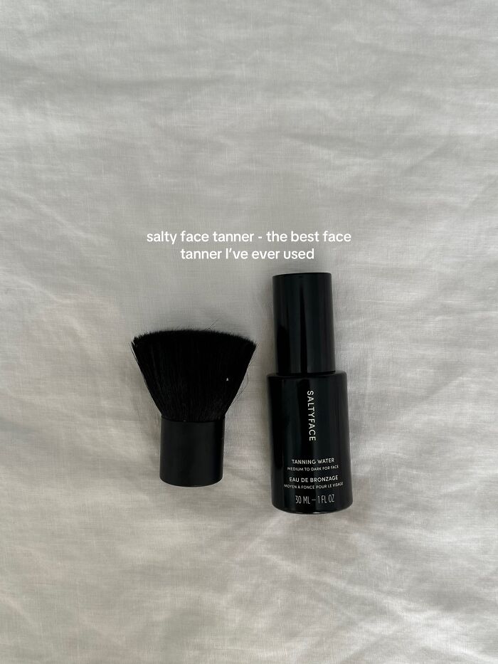 Salty Face tanning water and brush on a white fabric background, a highly recommended Christmas gift item.