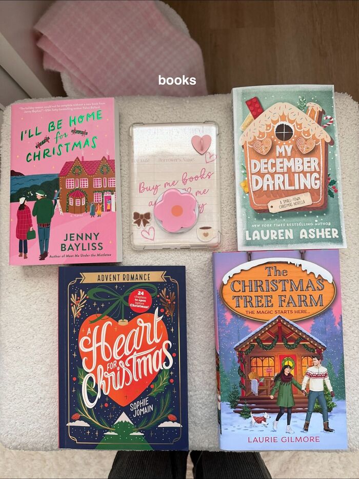 Christmas gift books arranged on a blanket, featuring festive holiday romance and heartwarming stories for the season.