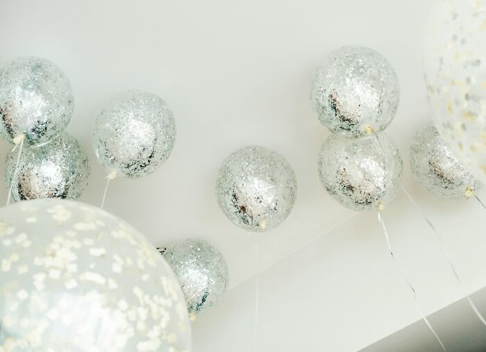 Silver balloons floating near a ceiling, symbolizing the secrets people trust strangers online with but keep private.