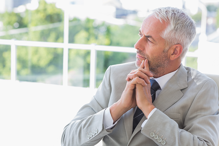 Mature man in a suit looking upset and thoughtful, reflecting on missed craft skills passed to half-brothers starting business. Mature man in a suit looking upset and thoughtful, reflecting on missed craft skills passed to half-brothers starting business.