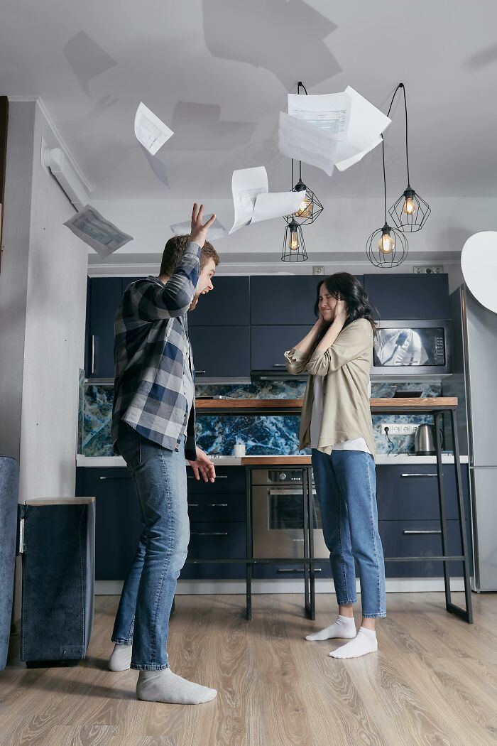 Couple experiencing conflict in a kitchen, illustrating challenges people who dated outside of their culture may face.