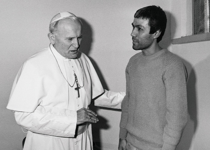 Black and white photo of two men in conversation, related to Cold Case of Vatican Girl who vanished decades ago.