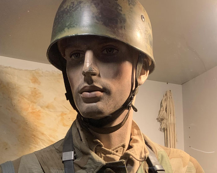 Mannequin wearing worn military helmet and uniform, representing disturbing things found in homes of seemingly normal people.