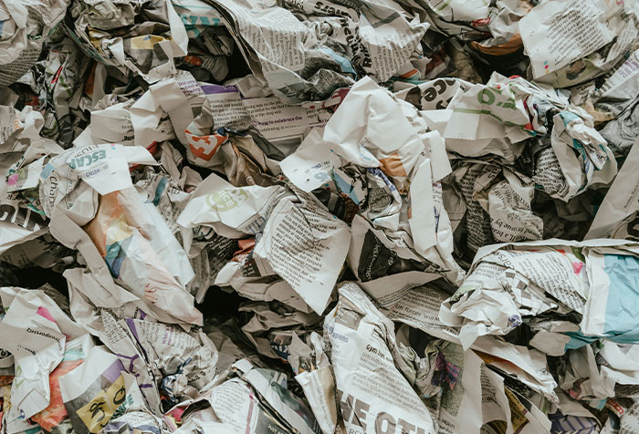 Crumpled and discarded papers scattered in a chaotic pile, illustrating disturbing things found in homes.