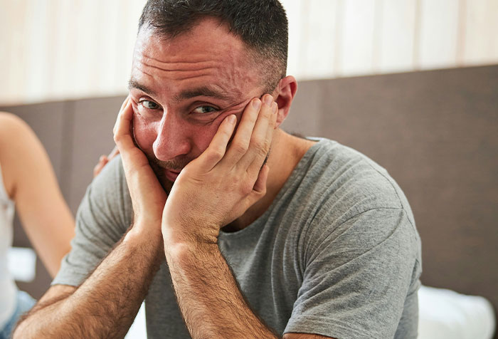 Man in casual grey shirt looking distressed in a home setting, reflecting on disturbing things found in seemingly normal homes.