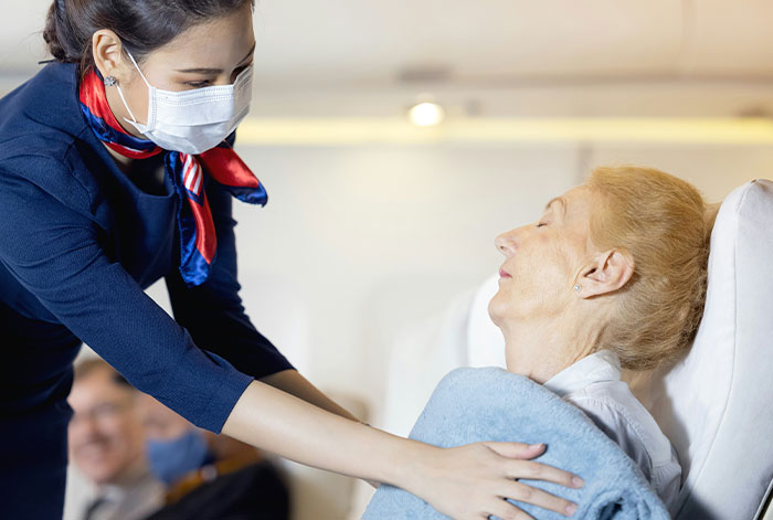 Flight attendant assists elderly woman on airplane as her lungs collapsed during takeoff emergency situation.