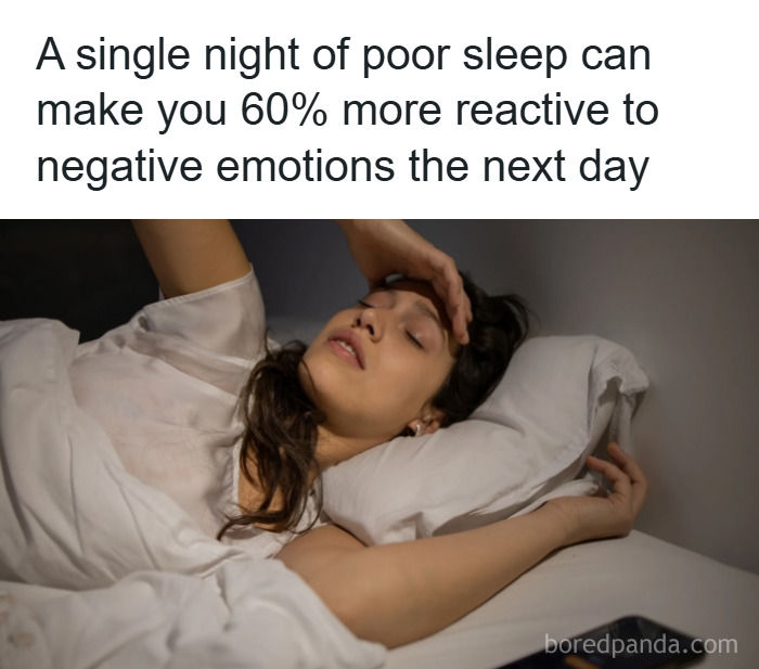 Woman lying awake in bed looking distressed, illustrating psychology facts about poor sleep and emotional reactivity.