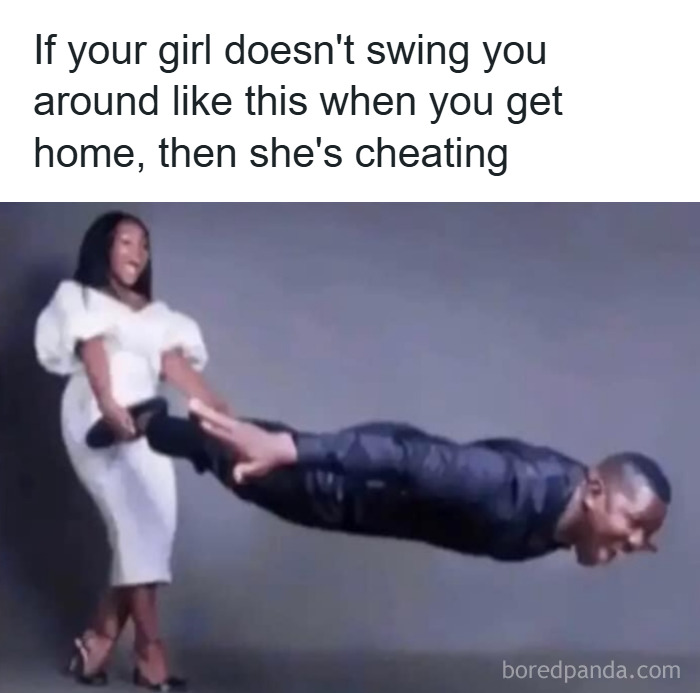 Couple performing funny unhinged meme pose with woman swinging man horizontally by his feet indoors.