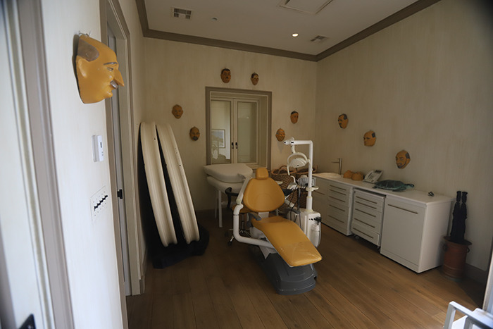 Dental chair and eerie face masks on walls in Epstein&rsquo;s private island home, revealing unsettling interior details.
