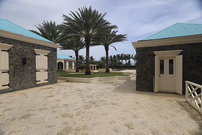 Eerie new images from Epstein&rsquo;s private island home showing stone buildings with blue roofs and tall palm trees outside