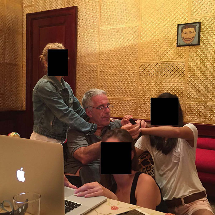 Man and three women with faces obscured sitting by a laptop, related to new Epstein files revealing photos of women. Man and three women with faces obscured sitting by a laptop, related to new Epstein files revealing photos of women.