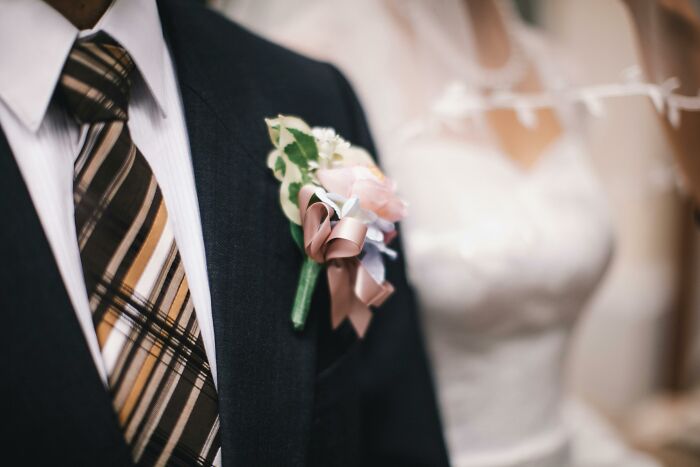 Close-up of a man in suit and tie with boutonniere, symbolizing a moment to test your moral compass and face dilemmas.
