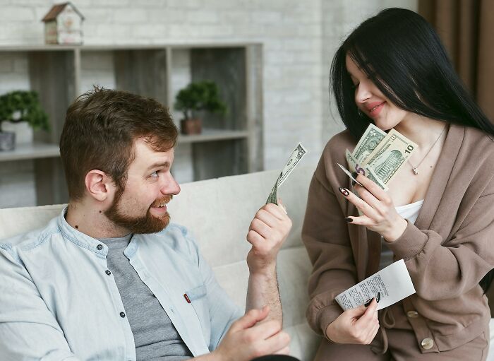 A young man and woman debating money with cash and a receipt, illustrating moral compass dilemmas in decision-making.