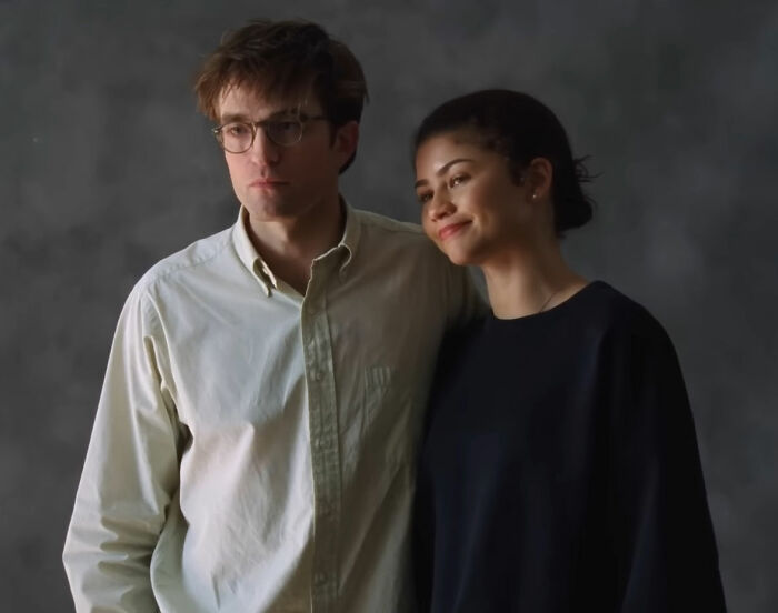 Robert Pattinson and Zendaya posing together in a promotional photo highlighting Zendaya’s engagement ring on his lap. Robert Pattinson and Zendaya posing together in a promotional photo highlighting Zendaya’s engagement ring on his lap.