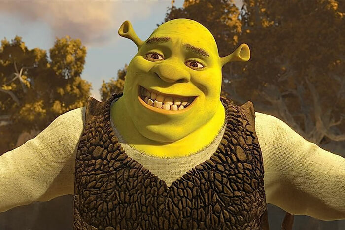 Animated character smiling widely in a forest setting, illustrating patients coming off anesthesia being too funny.