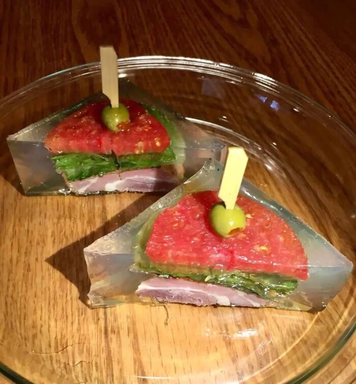 Unappetizing food pics showing gelatin-encased sandwich slices with tomato, lettuce, and olive on wood surface.