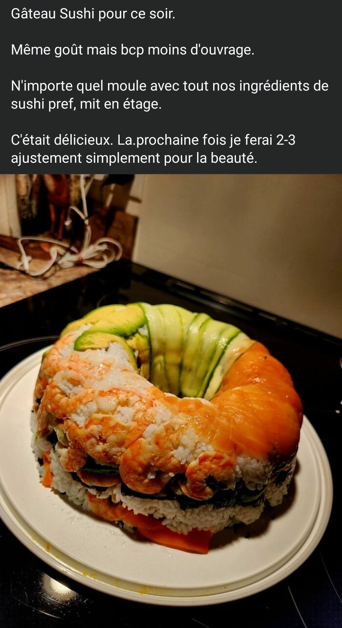 Homemade sushi cake shaped like a bundt with rice, avocado, shrimp, and salmon layers in a kitchen setting.