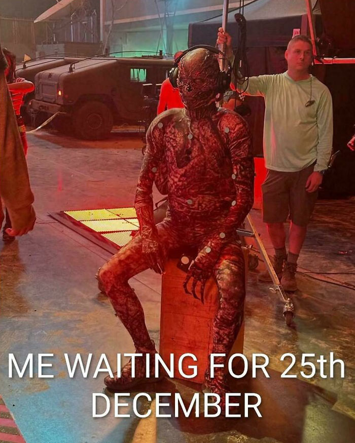 Stranger Things meme with creepy creature in costume on set, humorously waiting for December 25th release date.