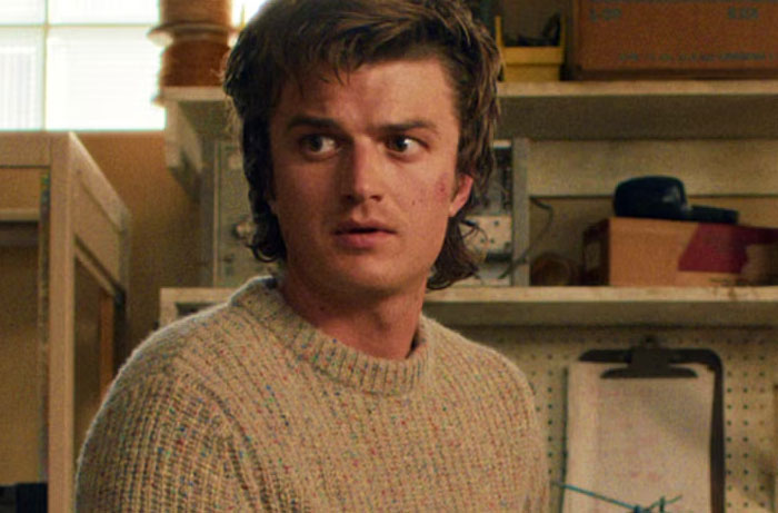 Character Steve Harrington from Stranger Things Season 5 looking surprised in a casual indoor setting.