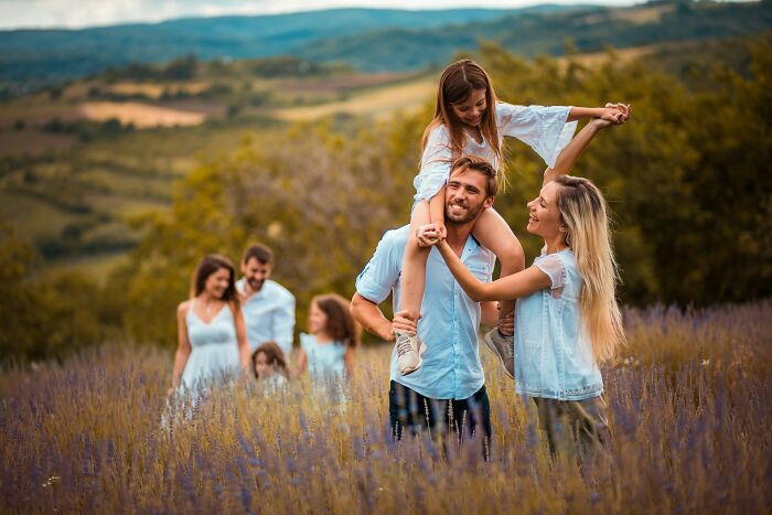 Family enjoying outdoors in a lavender field, highlighting harmless but toxic habits in everyday moments.