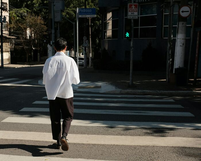 Person crossing street at a pedestrian crossing, symbolizing small decisions that changed the course of their lives.