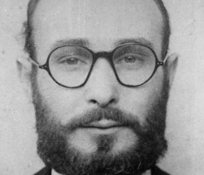 Black and white close-up of a man with glasses and a thick beard, relating to bizarre facts from history.