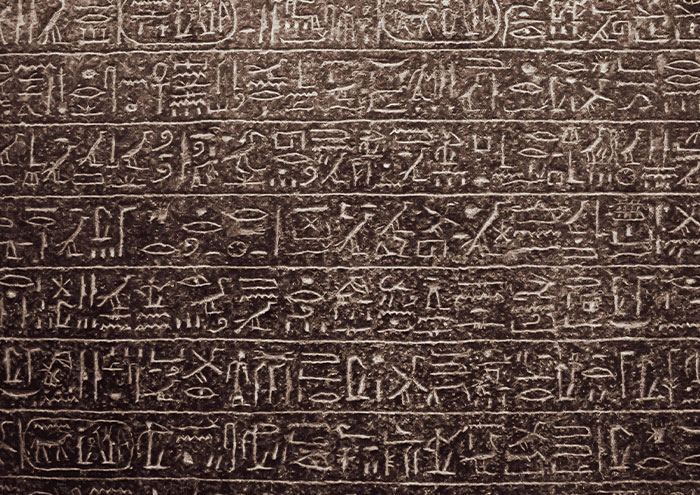 Ancient stone carving featuring bizarre facts from history with detailed and unexpected hieroglyphic inscriptions.