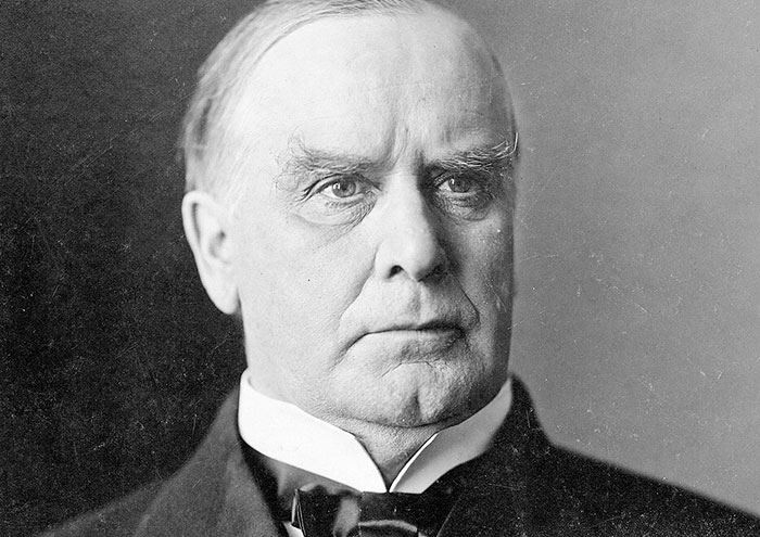 Black and white portrait of an elderly man wearing a suit, illustrating bizarre facts from history with a serious expression.