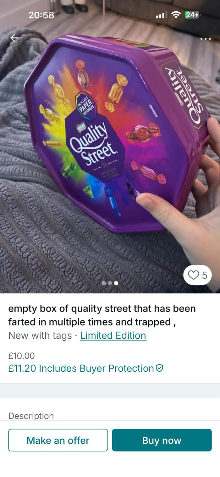 Hand holding empty Quality Street tin listed on Vinted in unhinged Vinted posts that had people doing a second take.