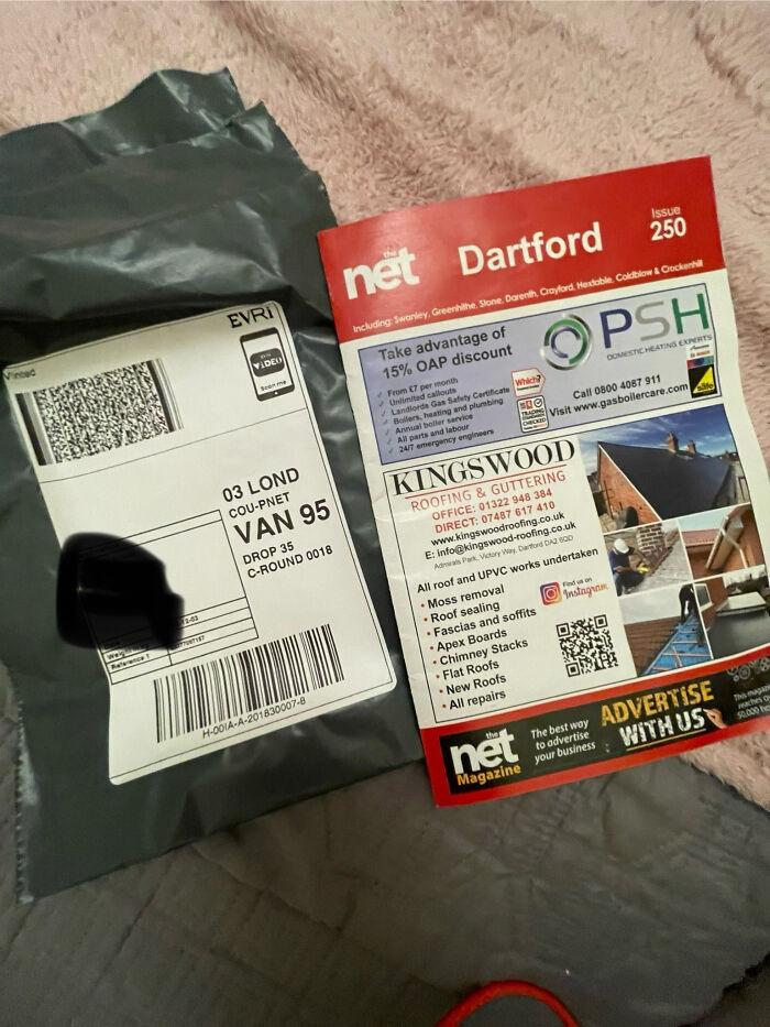 Grey shipping package and local magazine on a soft surface, illustrating unhinged Vinted posts that make people do a second take.