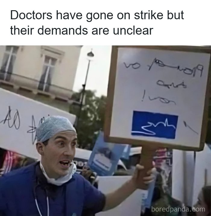 Doctor in scrubs holding a protest sign with unclear handwriting, illustrating a funny dad joke about strikes.