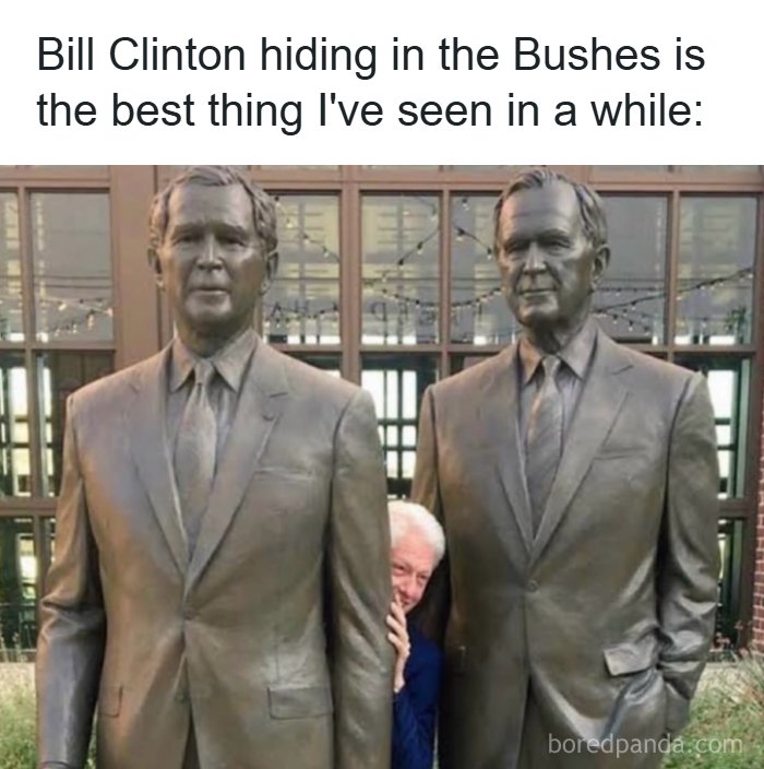 Bill Clinton playfully hiding between two statues of men in suits, a visual dad joke from a dad jokes account.