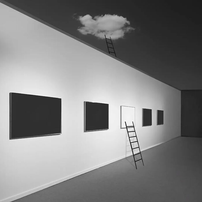 Black and white minimalist photo with square frames on a wall and a ladder reaching a cloud against a dark sky.