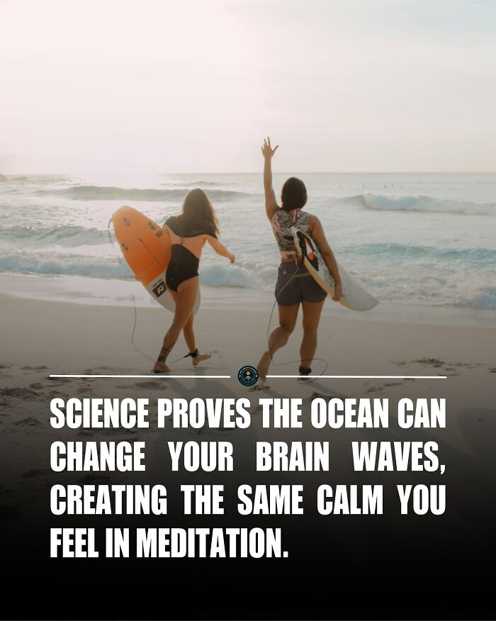 Two surfers walking on the beach holding surfboards, illustrating knowledge and facts about the ocean and the world.