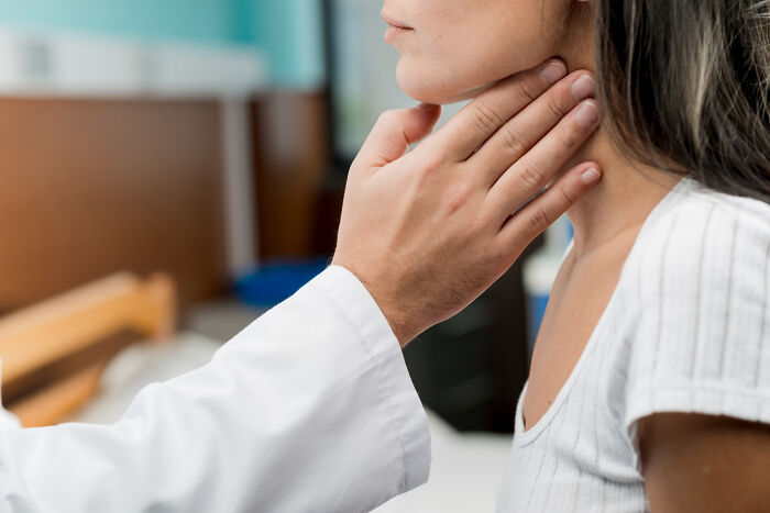 Doctor examining a patient's neck, highlighting fascinating human body features and facts in a clinical setting.